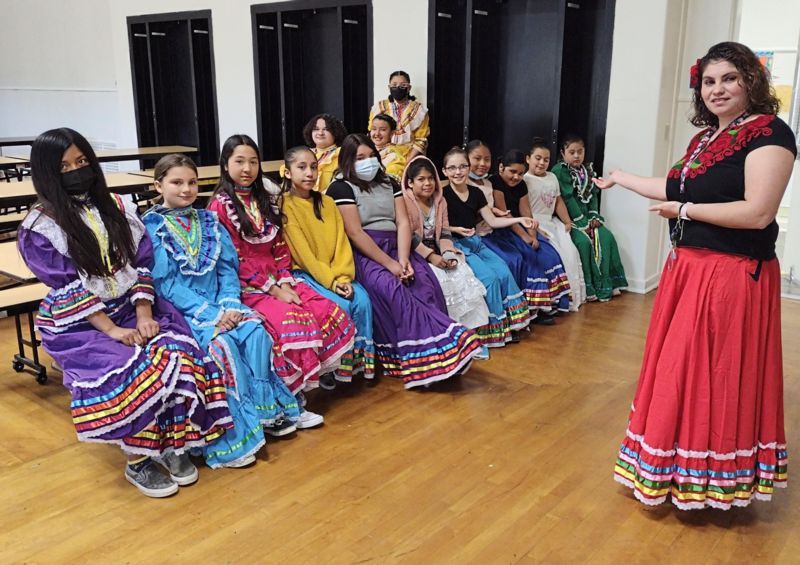 students and teacher wearing folklorico apparel